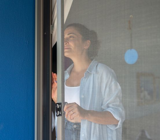 Woman Opening Mosquito Net Wire Screen Door At Home